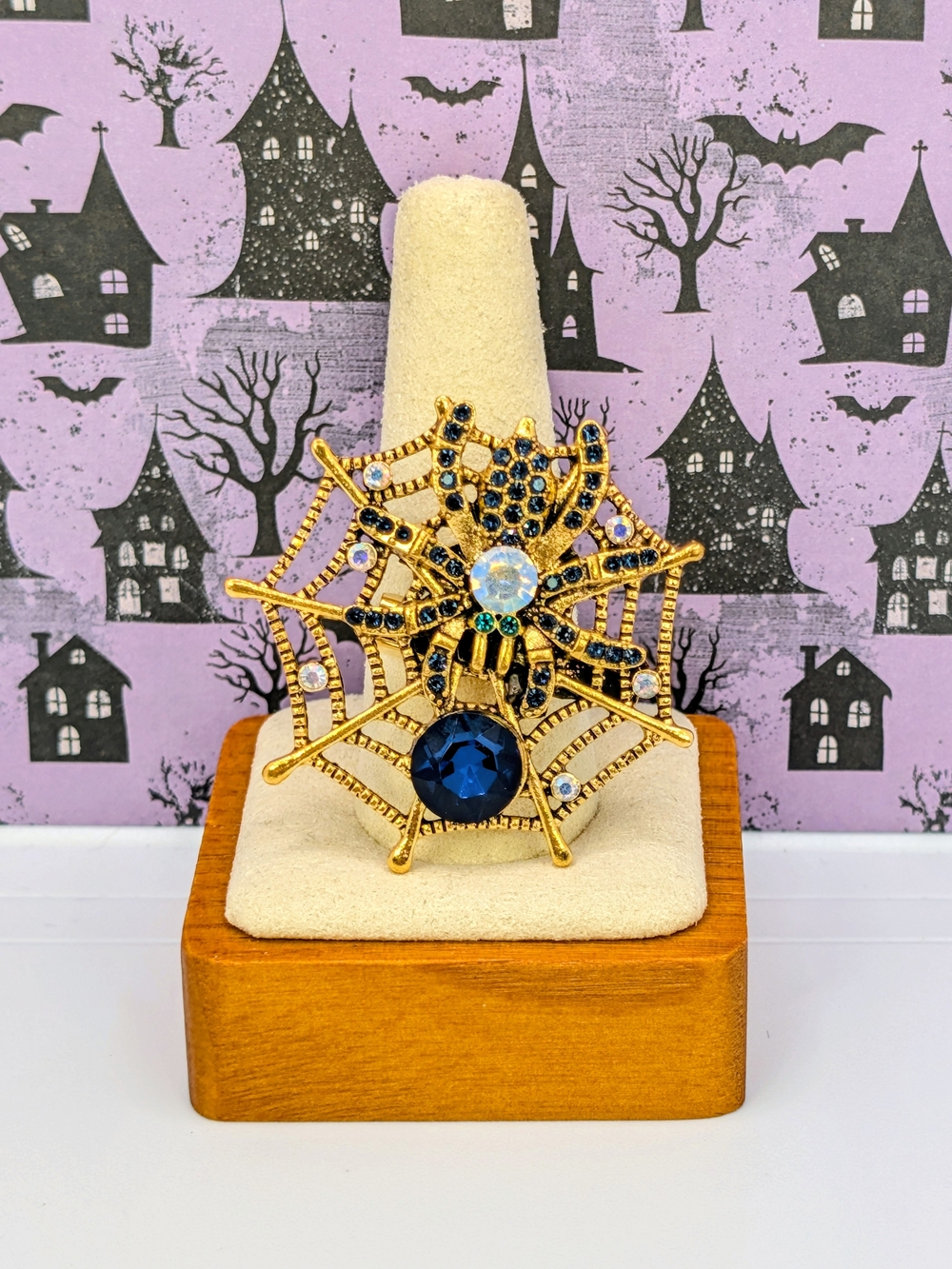 Gold Tone Spider Web Brooch with Dark Blue and Clear Rhinestones